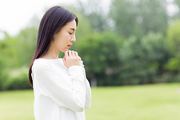 istock pretty girl in prayer 492148236