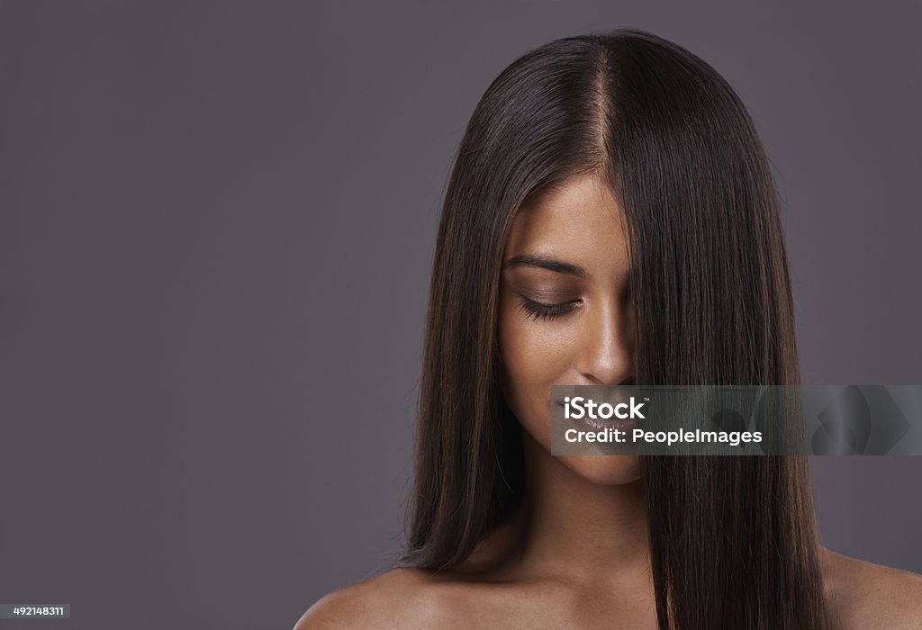 It's her crowning glory A young woman with sleek hair posing in studio Hair Part Stock Photo