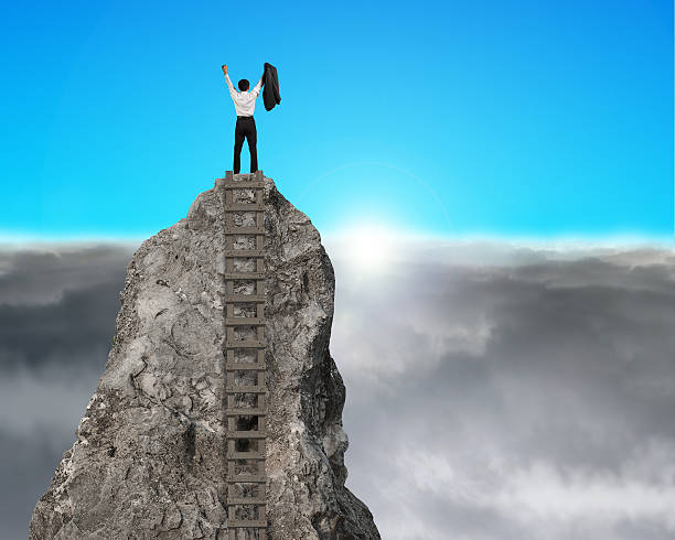 istock Cheering on top of rock mountain with sunrise 492148763