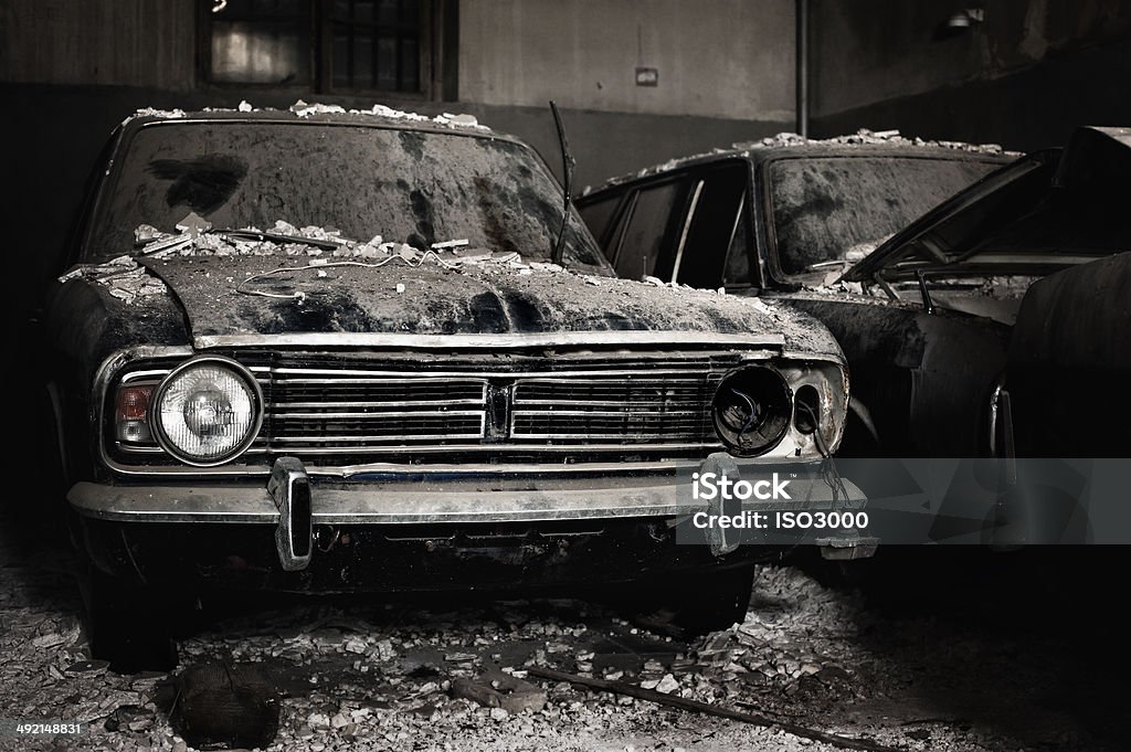Abandoned cars Abandoned cars in a dark dirty garage Junkyard Stock Photo