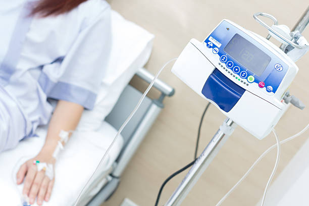 IV solution in a patient hand and IVS machine stock photo