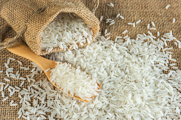 istock Jasmine rice with wooden spoon for background 492149656