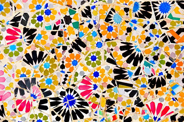 Photo of Colorful tiles patchwork close up in Gaudi Park Barcelona Spain