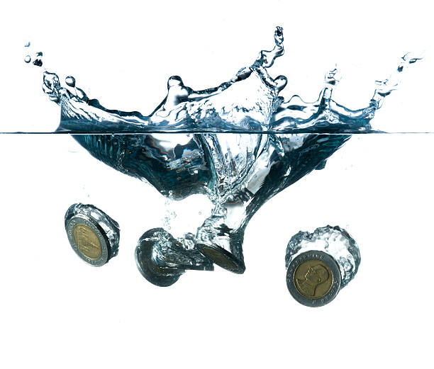 istock money in water with bubbles on white background 492151283