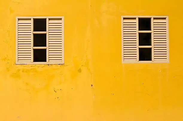 white window on yellow wall