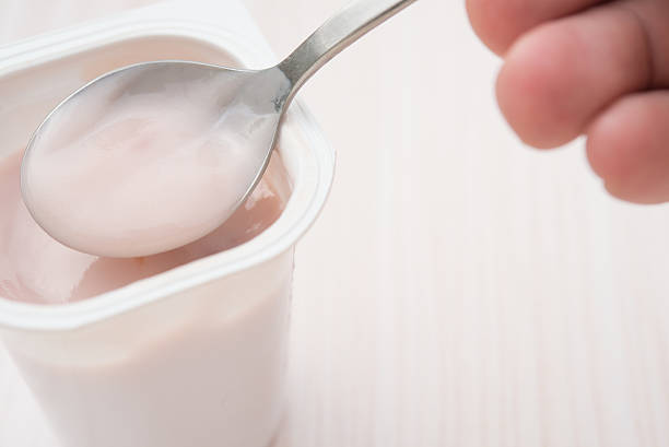 istock eating strawberry flavor yogurt close up 492152332