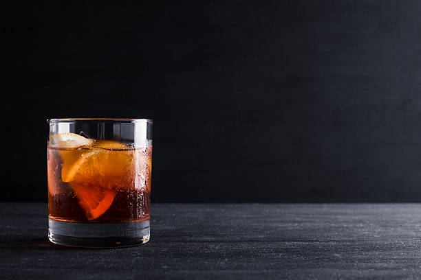 Old fashioned cocktail Old fashioned cocktail on the wooden background amber black photography stock pictures, royalty-free photos & images
