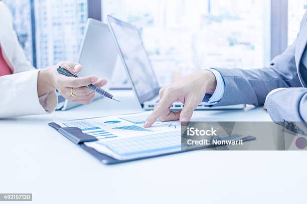 Business People Discussing The Charts Stock Photo - Download Image Now - 2015, Adult, Analyzing