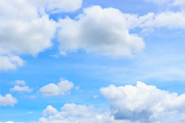 istock white fluffy clouds in the blue sky 492157214