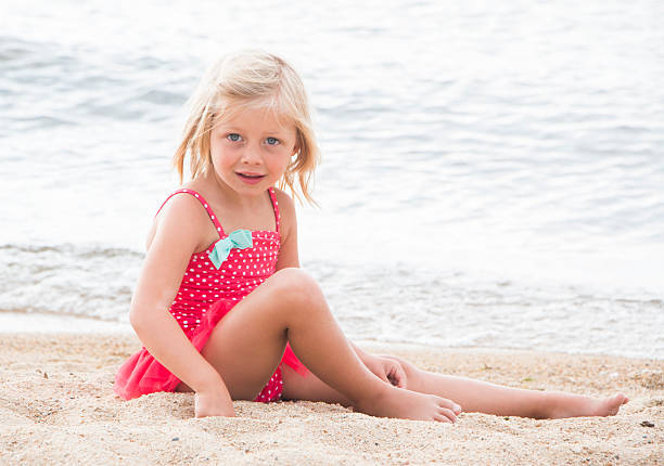 istock Little Girl Sunbathing on the Beach 492159364