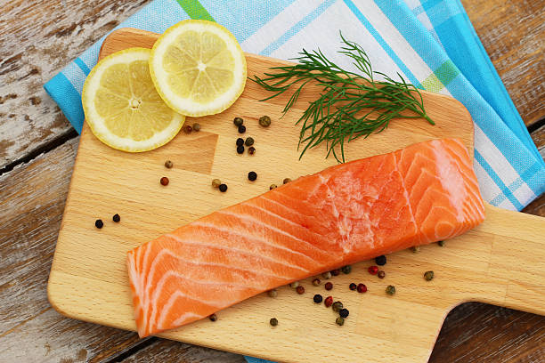 istock Raw salmon fillet on wooden board 492189100