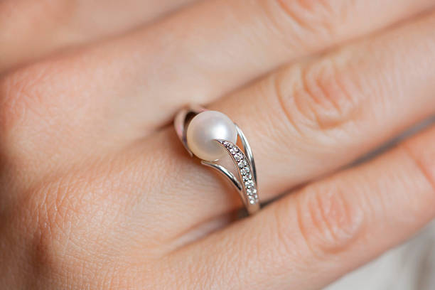 istock Woman's hand wearing a pearl ring 492189664