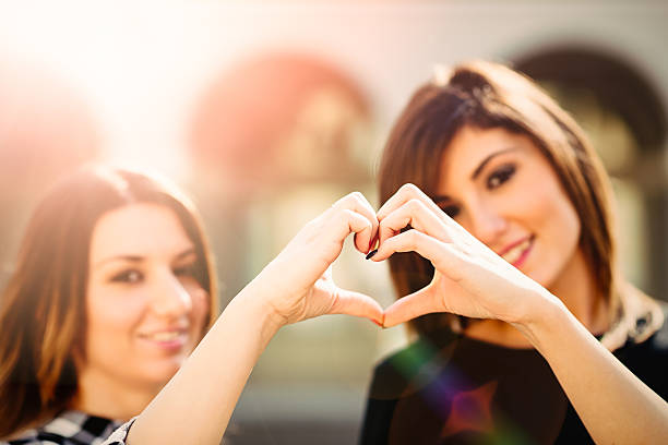 istock Two young woman making a heart shape by hands 492194718