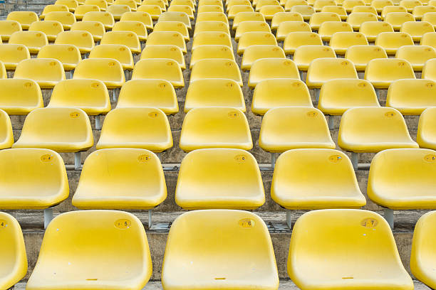 istock Field of empty yellow plastic stadium seats. 492194935