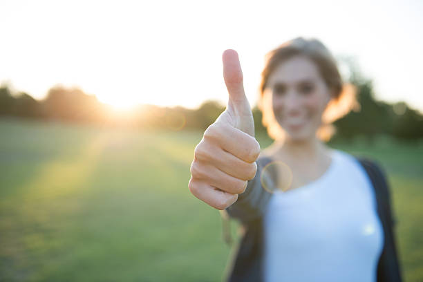 istock Young woman with thumbs up 492197646