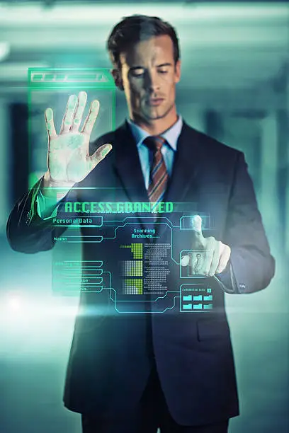 Cropped shot of a handsome young businessman using a digital interface