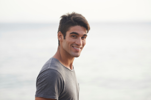 Cropped shot of a handsome young man on the beach