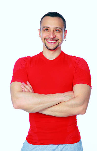 istock Cheerful sports man standing with arms folded 492198185