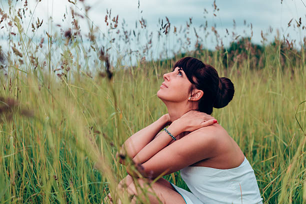 istock Girl sitting and posing on a meadow 492199284