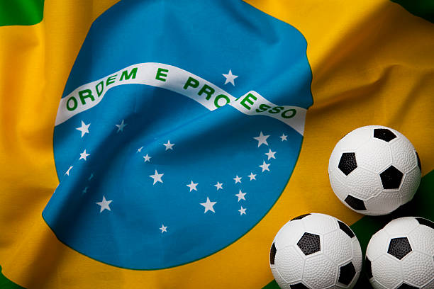 istock Brazilian Flag With Three Footballs 492199461