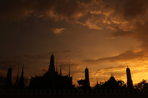 The temple end in the evening mood with the Wat Phra Keo at the Royal Palace in the historic center of the capital Bangkok in Thailand.