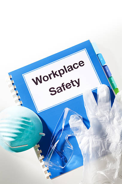 istock Workplace Safety Equipment, Handbook Manual with Mask, Gloves, Goggles Vertical 492199763