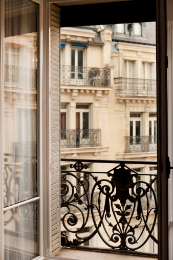 French style window and balcony in Paris, France.