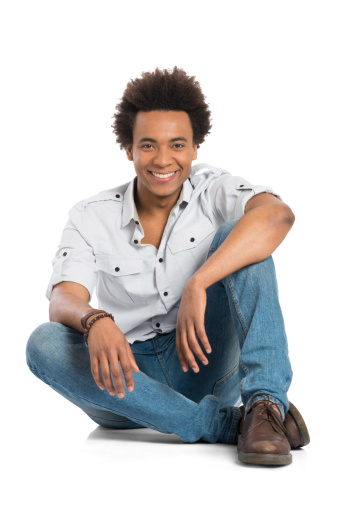 Portrait Of Happy Young African Man Sitting Isolated On White Background