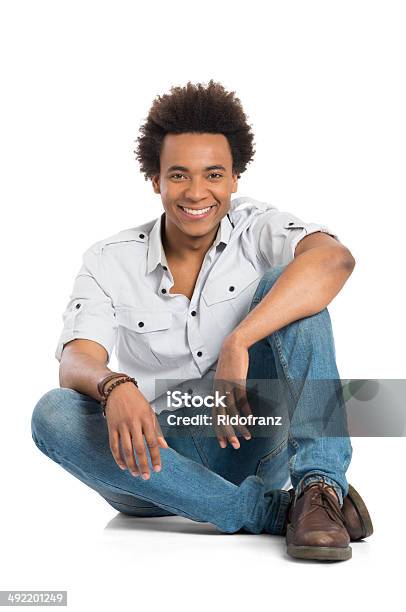 Smiling African Man Sitting Stock Photo - Download Image Now - Men, Sitting, Black Color