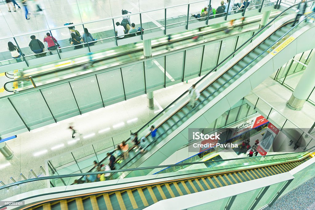 Staircase in Hong Kong International Airport, China, Asia Escalators inside Hong Kong International airport, China, Asia. Crowd of People Stock Photo