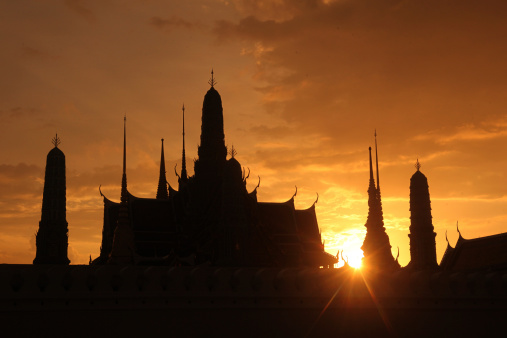 The temple end in the evening mood with the Wat Phra Keo at the Royal Palace in the historic center of the capital Bangkok in Thailand.