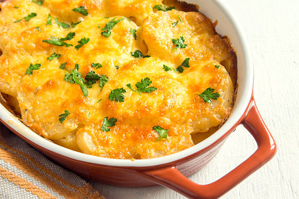 Potato gratin Potato gratin with cream, cheese and parsley in baking dish seafood gratin stock pictures, royalty-free photos & images