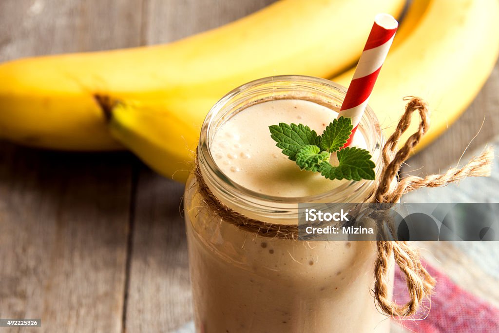 Banana smoothie Banana smoothie on wooden background 2015 Stock Photo