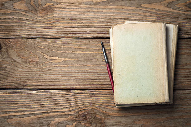 istock Old books on a wooden table with space for text 492225434