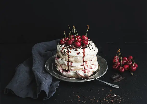 Photo of Pavlova cake with fresh cherry, cheese cream and chocolate chips