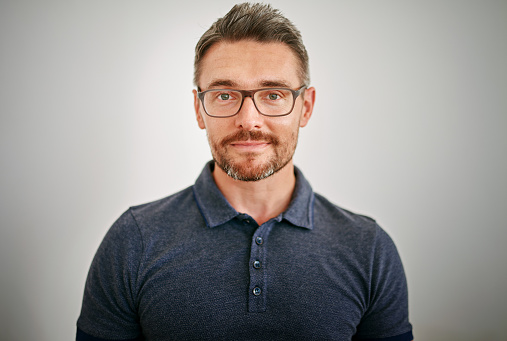 Portrait of handsome man in glasses on white background