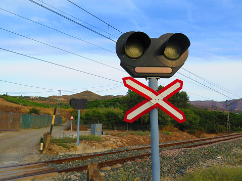 Lights and warning cross on ungarded level crossing in rural Andalucia