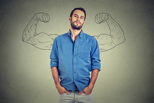 Strong man, self confident young entrepreneur Strong man, self confident young entrepreneur standing isolated on gray wall background. Arrogant bold self-important uppity snobbish stuck up man mental strength stock pictures, royalty-free photos & images