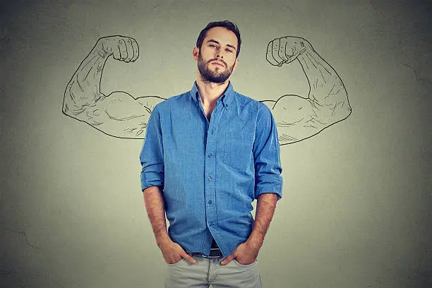 Strong man, self confident young entrepreneur standing isolated on gray wall background. Arrogant bold self-important uppity snobbish stuck up man