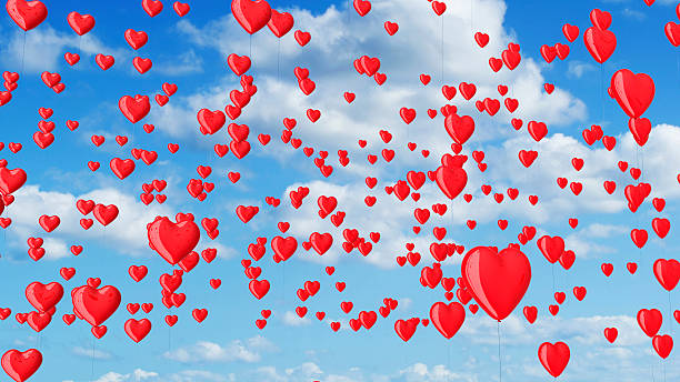 istock red heart shaped balloons in the blue sky with clouds. 492229300