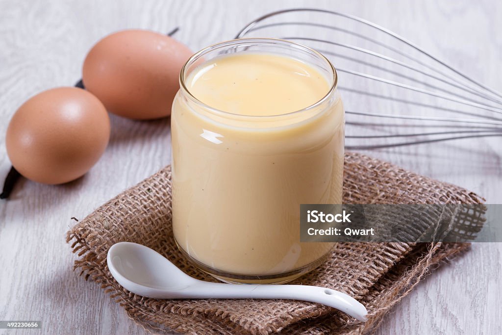 Custard in the glass jar with a spoon 2015 Stock Photo