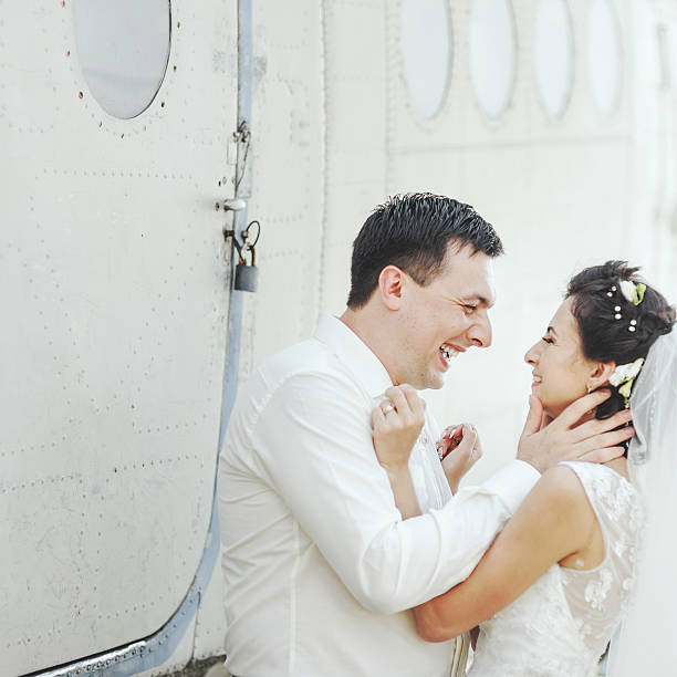 istock Wedding summer couple together posing against airplane. 492232824
