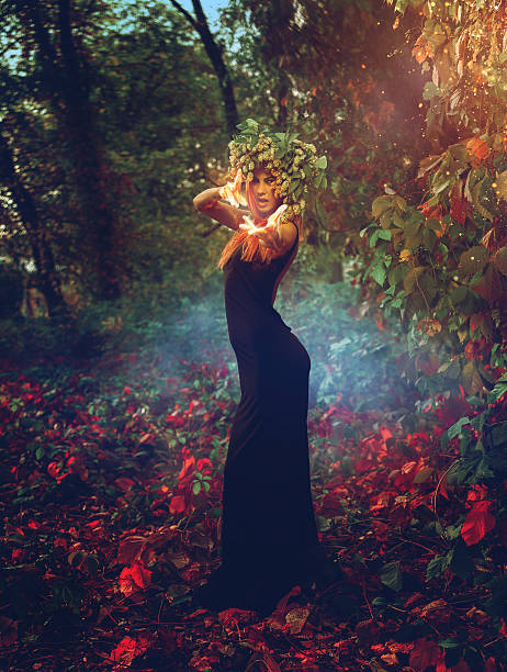 istock adorable young witch casts a spell in the woods 492248448