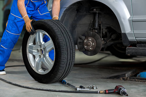 mechanic changing wheel of a modern car