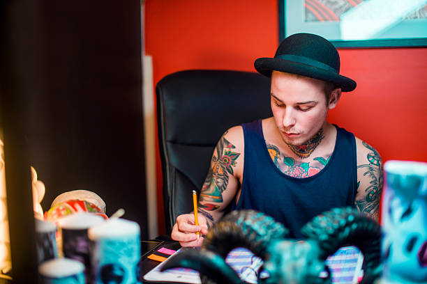 istock Male tattoo artist working at table 492253200
