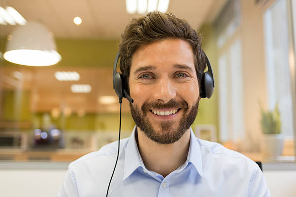 Smiling Businessman in the office on video conference, headset stock photo