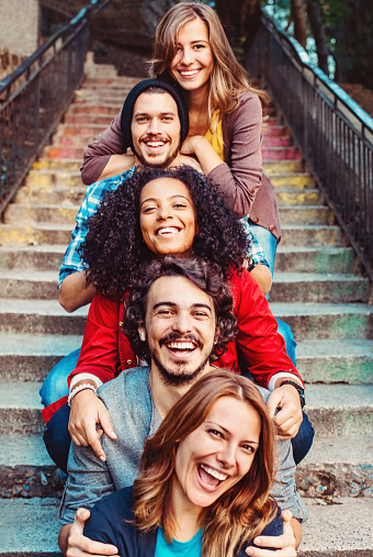 Mixed race young people laughing outdoors