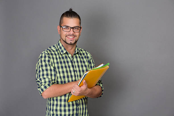 istock Fashionable hipster man holding documents in studio 492257658
