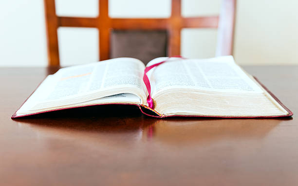 istock Open Bible and empty chair waiting for believer 492258717
