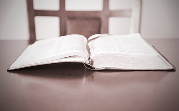 istock Open Bible and empty chair waiting for believer 492258719